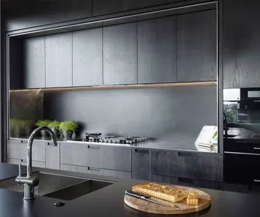 A striking black kitchen makes a stylish statement in this Auckland home