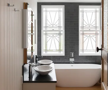 Two windows rescued from Trademe add major character to this bathroom