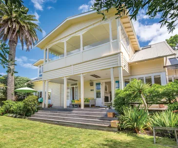 This incredible home for sale offers private beach access and lush gardens