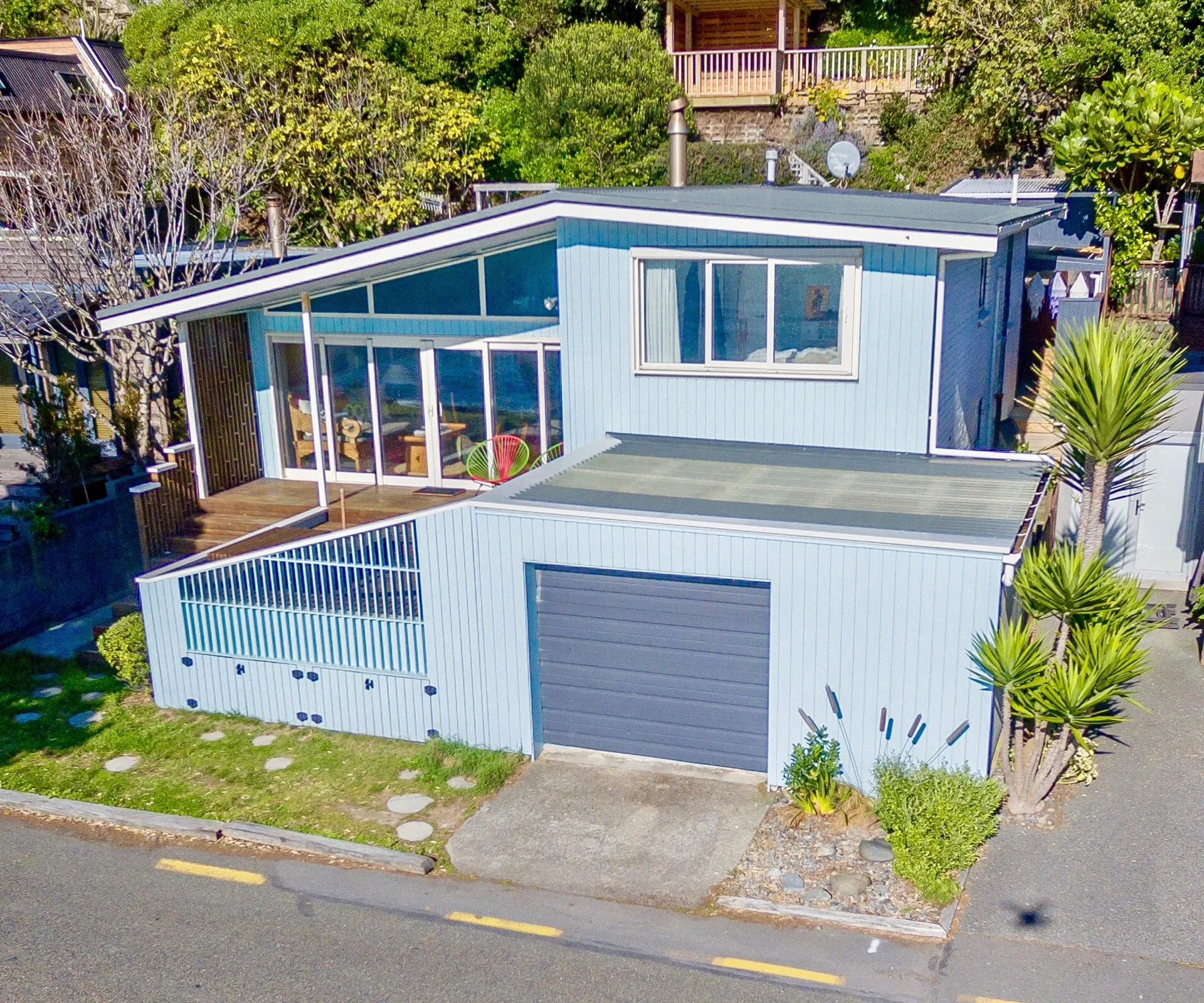 This classic Kiwi bach in Porirua has a prime waterfront location