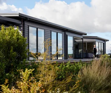 This striking black-clad home brings Tuscany and New York to Matakana