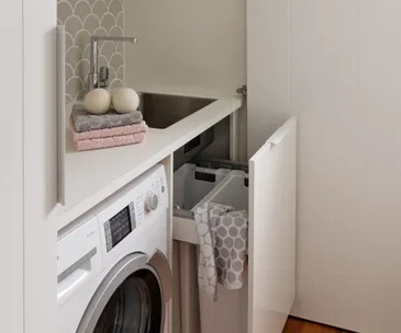 This cupboard laundry achieves style and practicality in a small space
