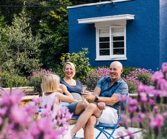 Inside a bold blue Art Deco home with an outdoor speakeasy bar