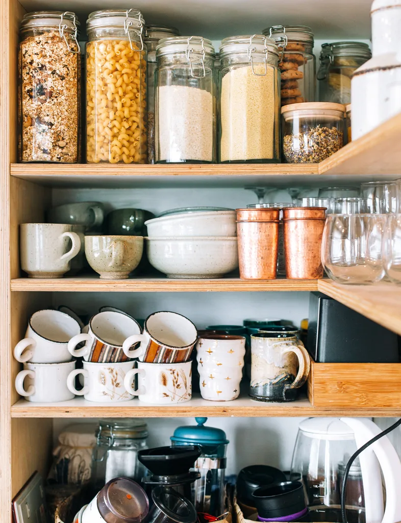 Packed shelves with mugs and jars