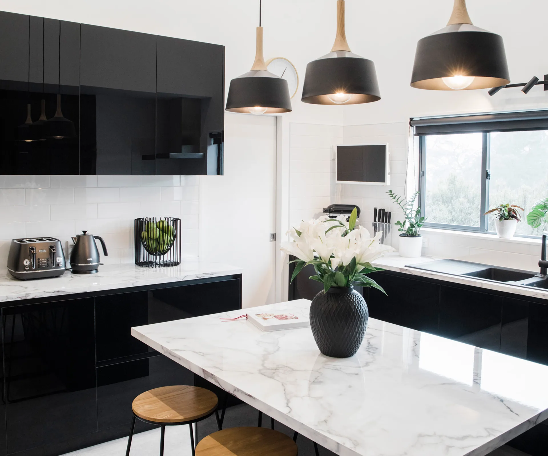 This glam black and white kitchen balances family practicality with style