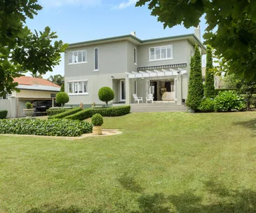 This elegant Tauranga home for sale comes with a beautiful formal garden