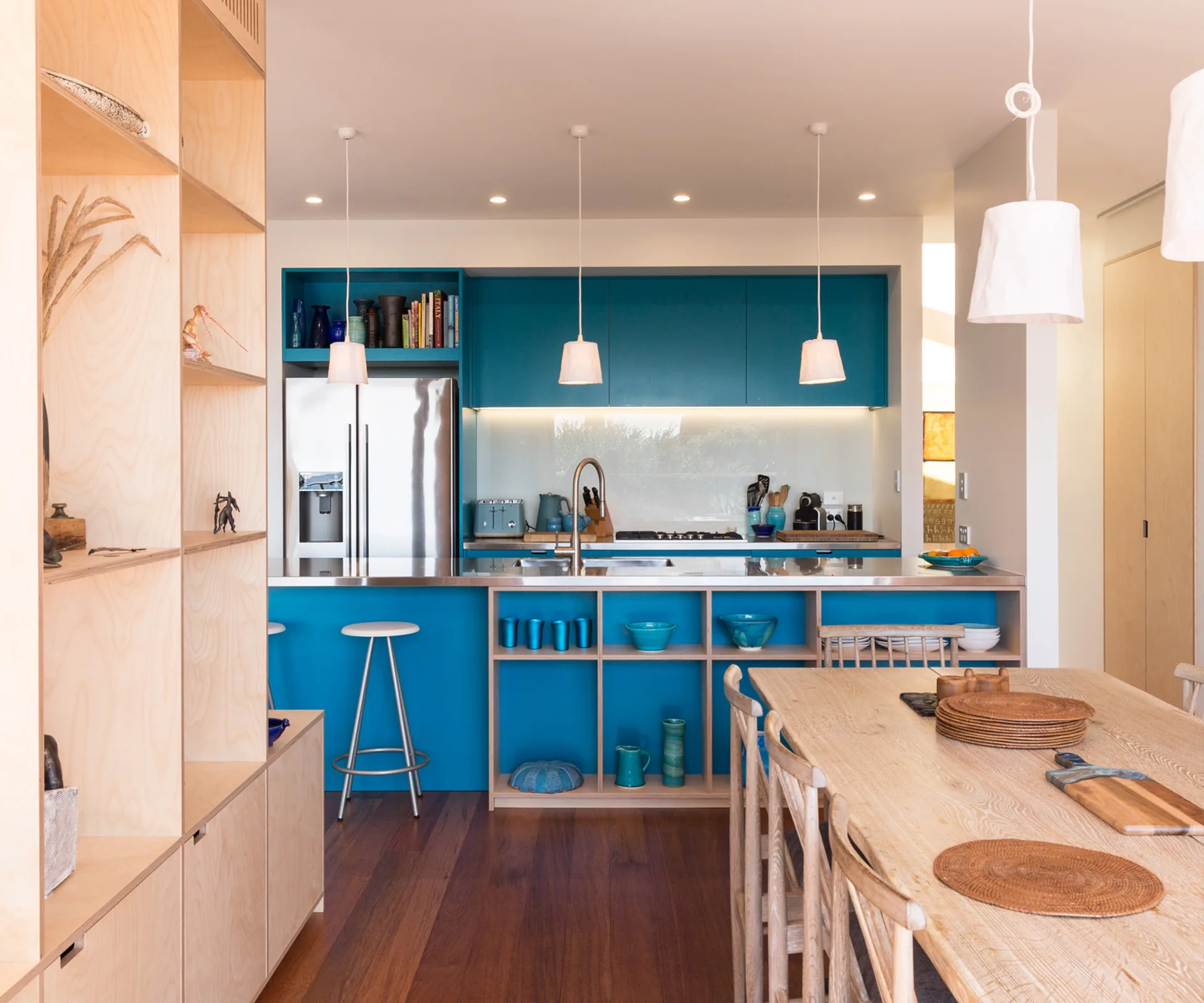 This sunny seaside home has a blue bathroom to match its bold kitchen