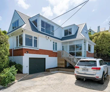 This fabulous family home comes with ocean views and a superb location