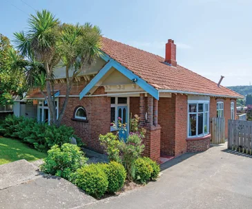 This classic brick home comes with a big deck and incredible views