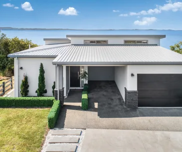 This clifftop home in Clarks Beach comes with breathtaking sea views