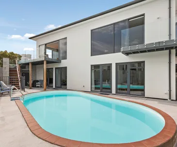 Enjoy a beachfront lifestyle in this generous 5-bedroom home