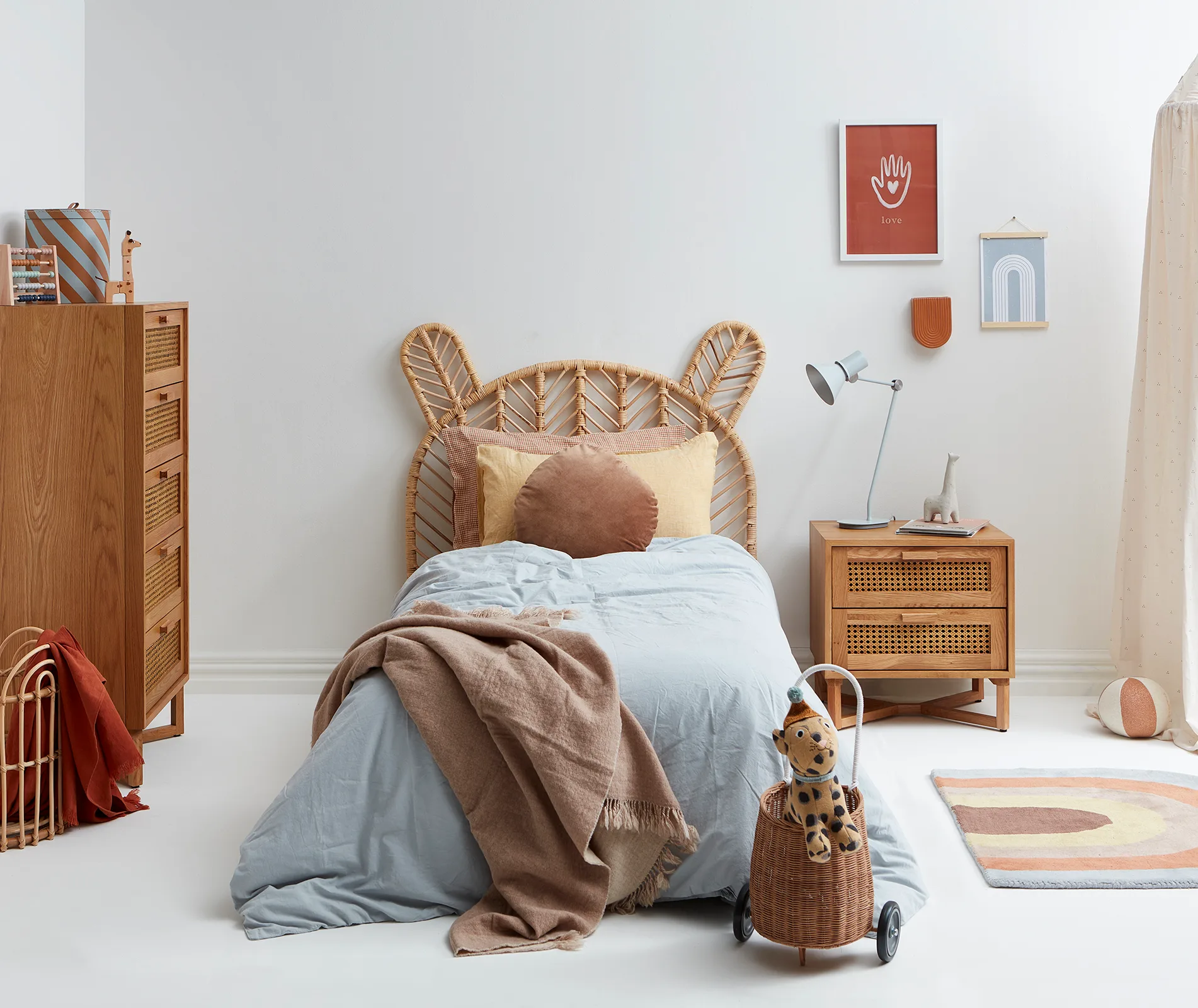 A gender neutral bedroom with a rustic bear-shaped headboard and a light blue duet