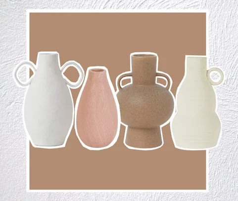 Four modern decorative vases in various shapes and neutral tones on a textured background.