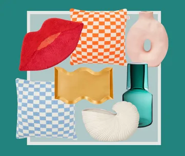 Home decor items: red lips pillow, orange and blue checkered pillows, abstract vase, wavy tray, green bottle, seashell vase.
