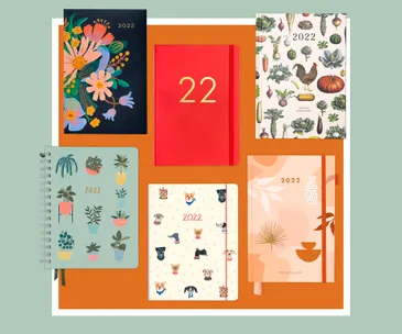 "Six 2022 planners with various colorful designs, featuring flowers, plants, animals, and abstract patterns."
