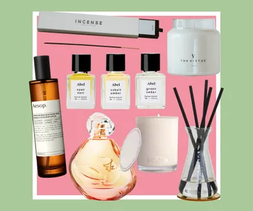 Various scented products including incense, perfumes, a candle, and a diffuser, displayed on a pink background.