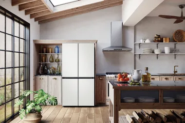 Modern kitchen with a Samsung refrigerator, wooden cabinets, skylight, and black-framed windows.