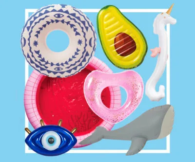 Pool floats in various shapes: eye, donut, avocado, seahorse, shark, and ring, arranged on a blue background.