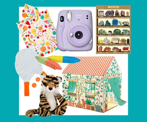 Colorful toys and items for kids, including a toy camera, play tent, plush tiger, paddle, and colorful crayons.