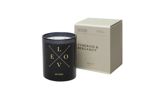 Black candle with "LOVE" design and box labeled "Tuberose & Bergamot" by Hivern New Zealand.