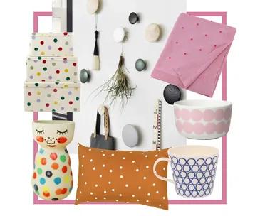 Polka dot themed decor items including boxes, wall hooks, textiles, and ceramics with colorful patterns and designs.