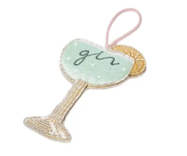 Embroidered ornament of a gin cocktail glass with a beaded lemon slice and a pink hanging loop.