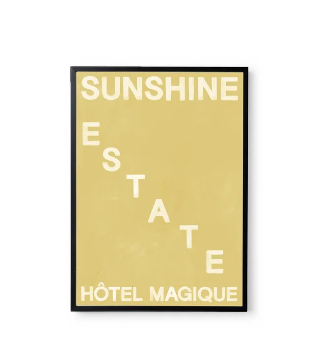 Framed poster with "Sunshine Estate Hôtel Magique" in white on a beige background.