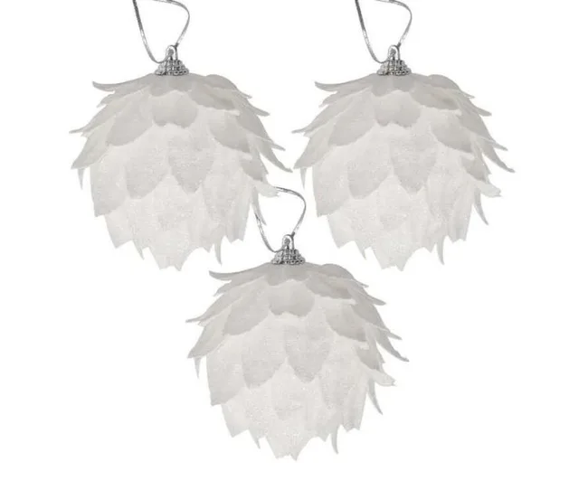 White flower-shaped Christmas ornaments with layered petals and silver hanging hooks, set of three.