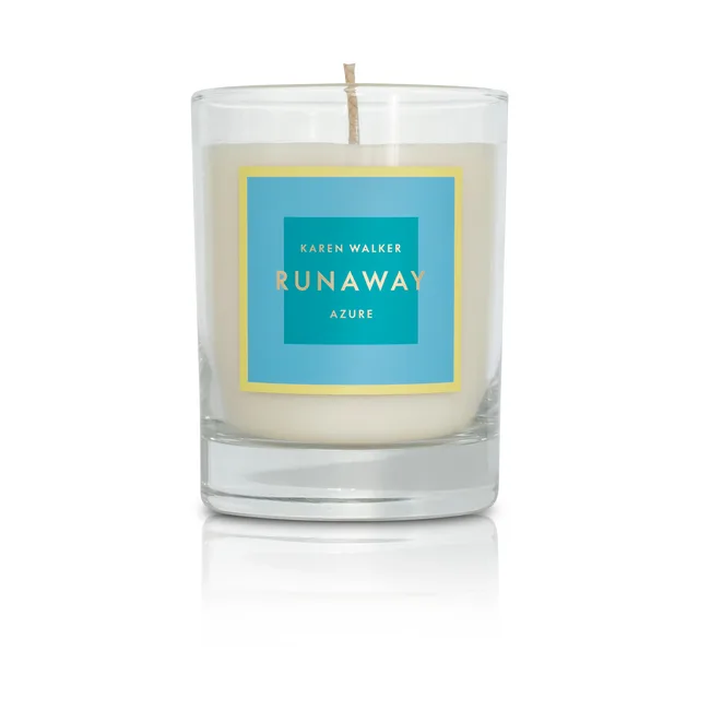 Karen Walker Runaway Azure candle in a glass holder with a blue and yellow label.