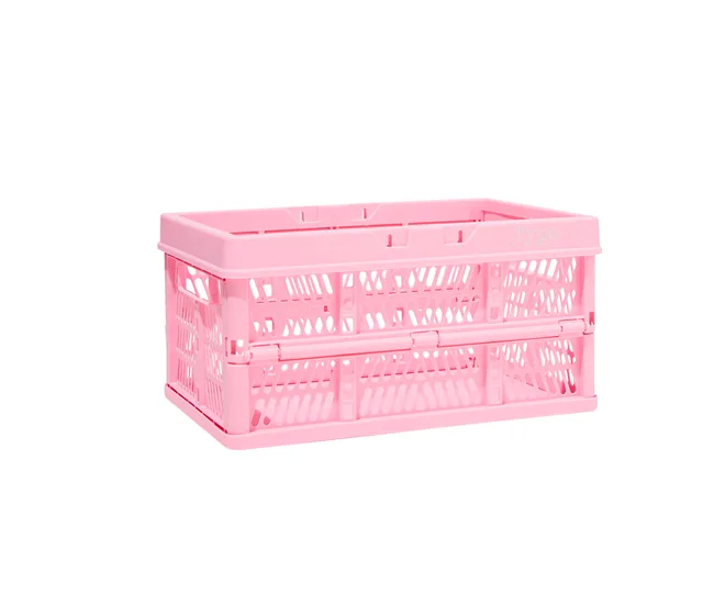 Pink collapsible plastic crate with perforated sides on a white background.