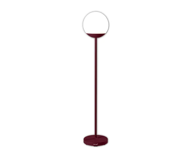 Red floor lamp with a circular white lampshade and a round base.