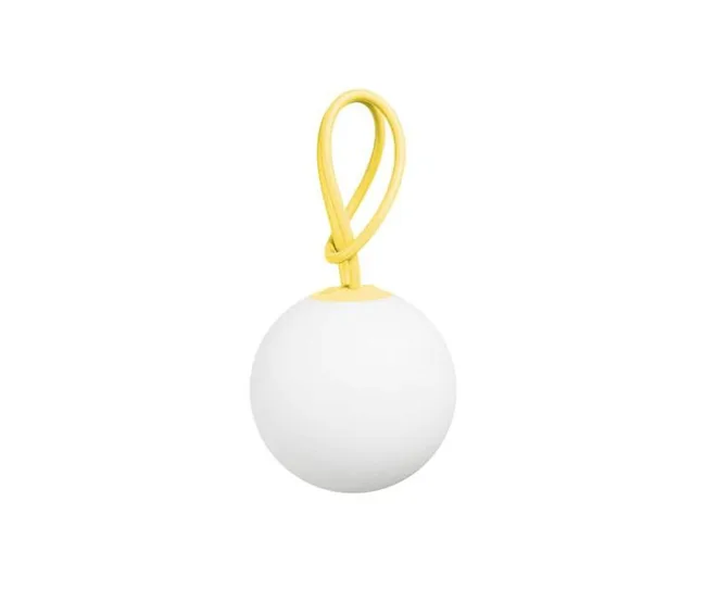 Round white speaker with a yellow loop handle against a white background.