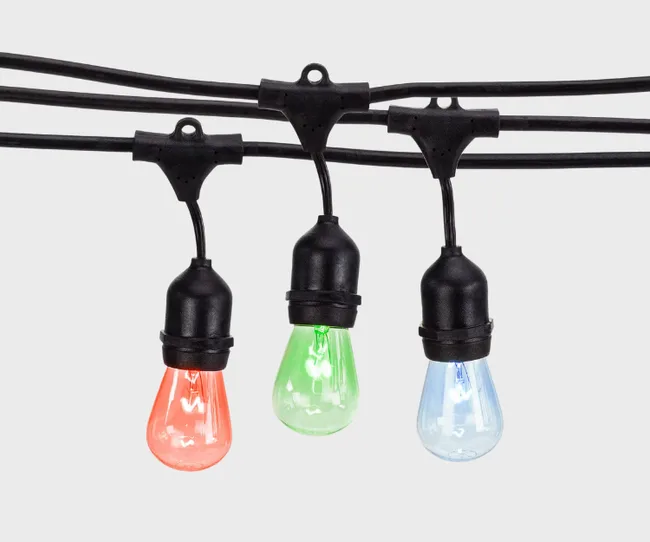 Colored string lights with red, green, and blue bulbs on a black wire against a plain background.