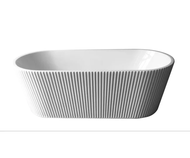 White ribbed freestanding bathtub with an oval shape on a white background.