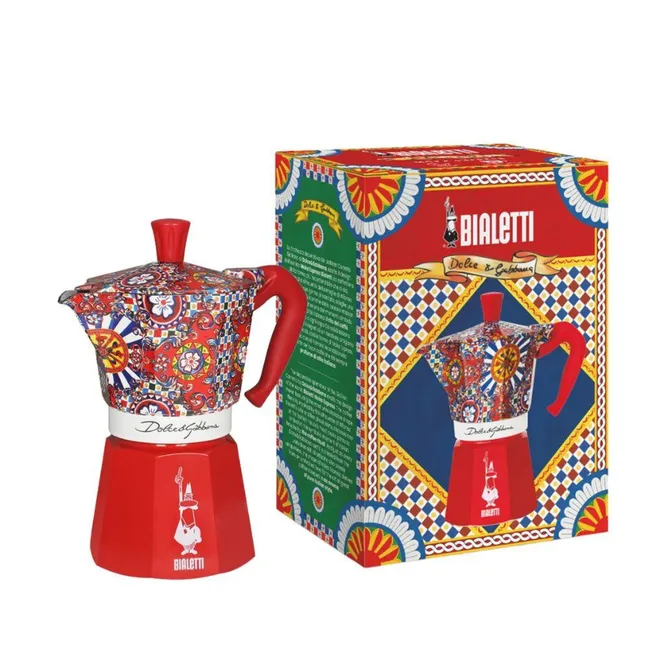 Bialetti moka pot with colorful Dolce & Gabbana design next to matching box.