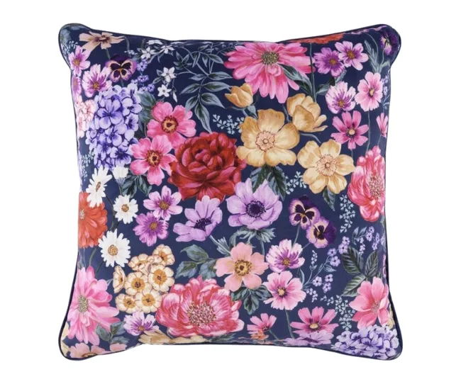 Floral cushion with vibrant flowers in red, pink, yellow, and purple on a dark background.