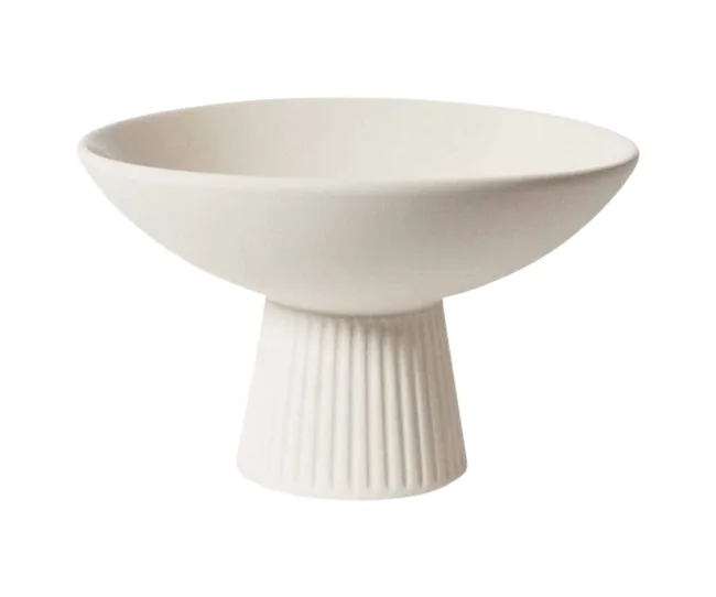 White ceramic footed bowl with a wide brim, fluted base, and minimalist design.