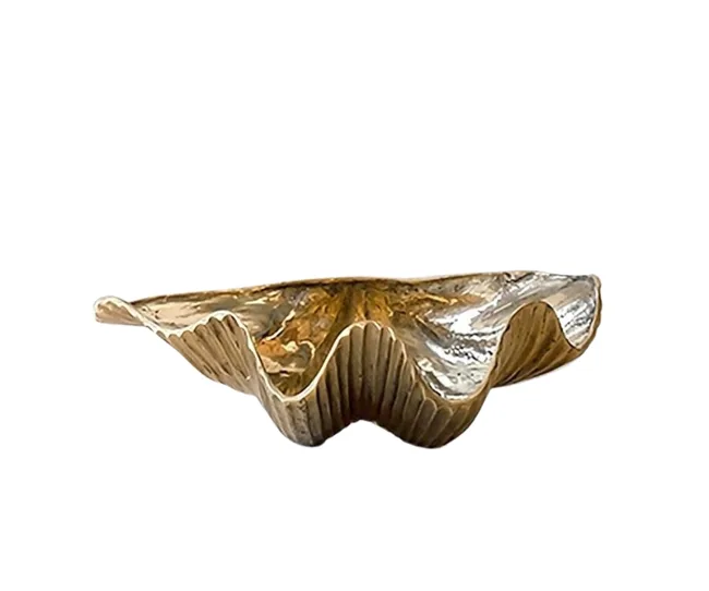 Gold clam-shaped decorative bowl with a textured surface.