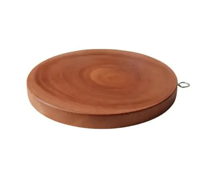 A round wooden chakla (rolling board) with a metal ring attached on one side for hanging.