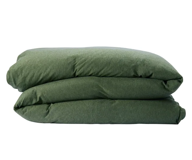 Folded green comforter against a white background.
