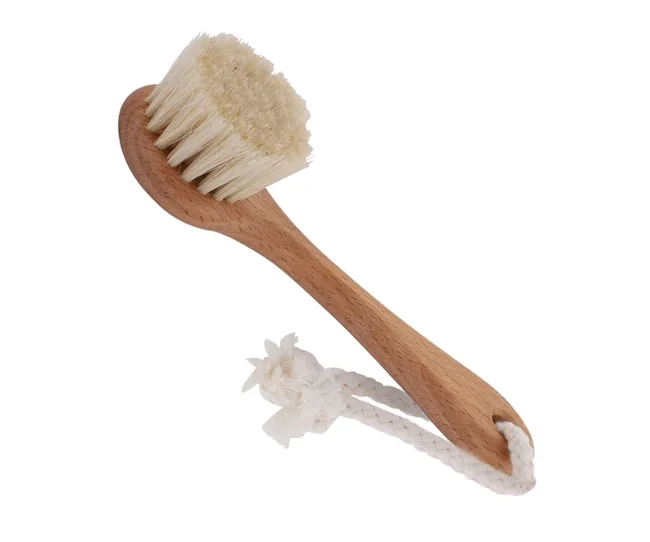 A wooden body brush with natural bristles and a rope loop attached to the handle.