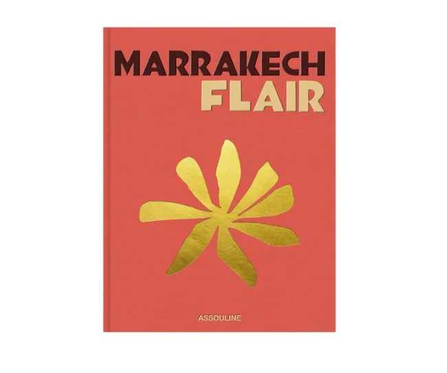 Cover of "Marrakech Flair" by Assouline, featuring bold text and a golden abstract flower on a red background.