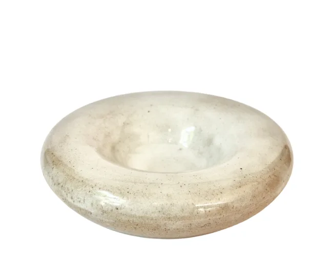 Smooth, round, beige stone bowl with a shallow center, set against a white background.