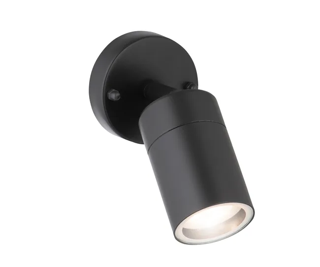 Black cylindrical LED wall spotlight with a round base, tilted downward, illuminating its surroundings.