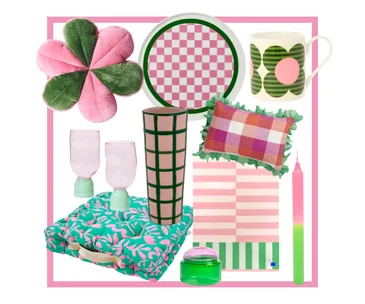 Decorative home goods including a pink flower pillow, checkerboard tray, vase, mugs, and cushions in vibrant colors.