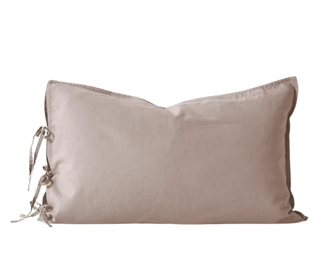 Beige rectangular pillowcase with tied bows on one side.