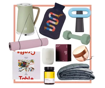 Assorted lifestyle items including a kettle, dumbbell, yoga mat, puzzle, and weighted blanket.