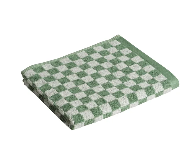 Folded green and white checkered towel on a white background.