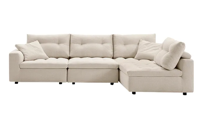 Beige sectional sofa with plush cushions and two accent pillows.