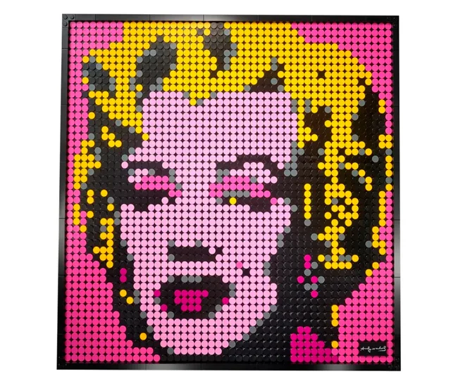 Pixel art of Marilyn Monroe in pink, yellow, and black made from LEGO bricks, inspired by Andy Warhol's pop art.